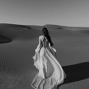 Woman in flowing dress in desert